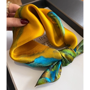 Golden silk square scarf with blue-green art patterns and smooth satin finish