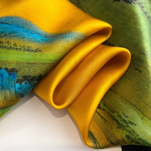Macro view of real silk scarf featuring landscape oil painting print and glossy texture