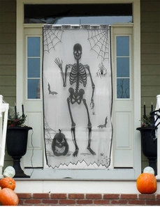Macro view of black lace Halloween curtain with skull, spider web and bat patterns