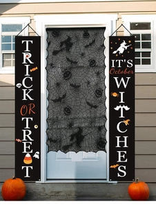 Detail of Halloween black lace spiderweb curtain and festive Trick or Treat porch banners