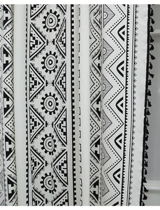 Detail of bohemian geometric print curtain with black tassels and tribal cotton linen fabric