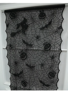 Detail of Halloween black lace curtain with spider web, bats, and pumpkin patterns