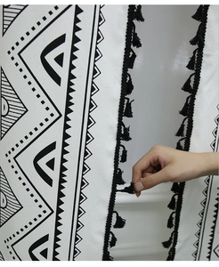 Detail of bohemian geometric print on linen fabric with black tassel edge for kitchen curtains