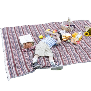 Bohemian style woven picnic blanket with fringe edges for outdoor camping and home decor