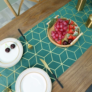 Modern emerald green velvet table runner with gold geometric patterns for dining decor
