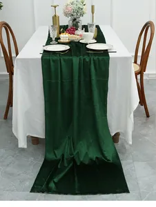 Close-up of luxury dark green velvet table runner showing soft texture and premium drape