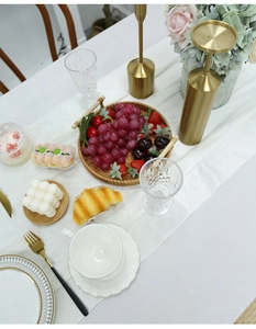 Flat lay of cream velvet table runner with gold cutlery and elegant floral decor