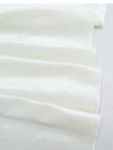 Detail of white Italian velvet table runner with smooth texture and overlock stitched edges