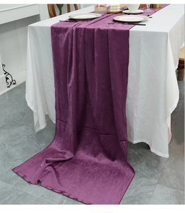 Close-up of purple velvet table runner featuring elegant scalloped edges for festive decor