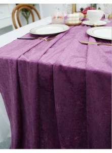 Close-up of luxury dark purple velvet table runner with elegant silky sheen and soft drapes