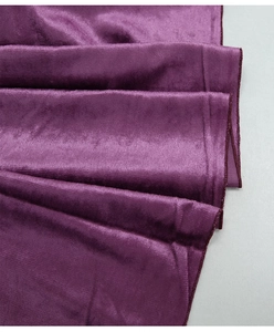 Detail of dark purple velvet table runner showing soft texture and silk-like sheen