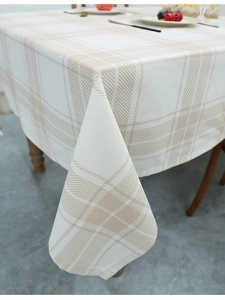 Close-up of cream and brown checkered cotton linen tablecloth with fine fabric texture
