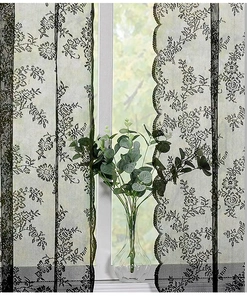 Detailed view of black wavy lace sheer curtain with delicate floral mesh pattern for windows