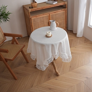 Close-up of white lace edge tablecloth with elegant crochet detail on a round table