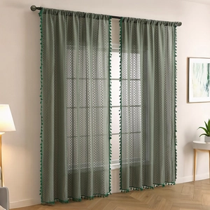 Dark green semi-sheer lace curtains with geometric patterns and tassel edges for windows
