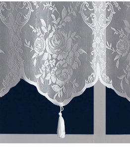 Detail of white rose lace curtain with jacquard patterns and elegant silk tassel