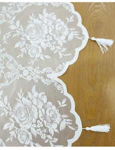 Detail of white rose lace curtain with exquisite floral embroidery and long tassel charm