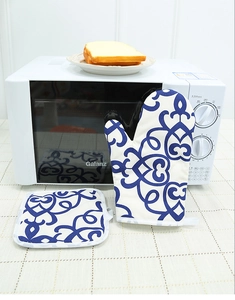 Close-up of Nordic oven mitt and pot holder set with vintage blue patterns on white