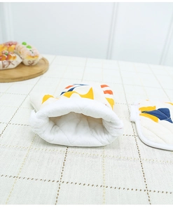 Nordic geometric oven mitt and pot holder set on checkered tablecloth for kitchen use