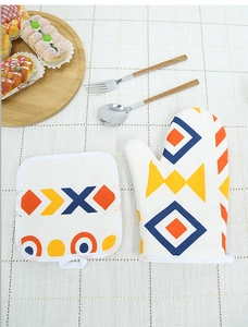 Detail of insulated oven mitt and pot holder set with colorful geometric patterns