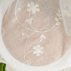 White floral embroidered sheer curtain with delicate petal patterns for living room