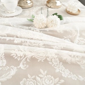Elegant white French lace tablecloth with embroidered roses and romantic fringe details