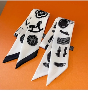 Close-up of elegant silk twilly scarves featuring camellia and fashion icons in monochrome