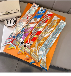 Detail of silk twilly scarves with horse and chain prints for handbag handles