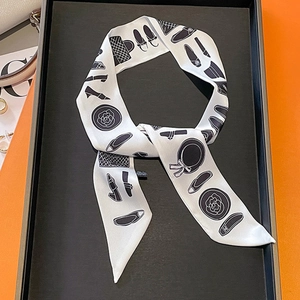 Fashion narrow silk scarf with camellia and shoe prints on orange display tray