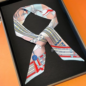 Detailed macro view of 100% silk twilly scarf with equestrian print in luxury gift box