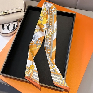 Macro detail of the silk twilly scarf with elegant chain and buckle horse print