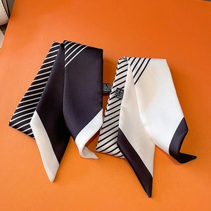 Classic black and white striped polyester twilly scarf set on orange background