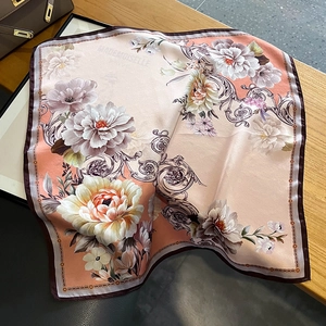 Close-up of vintage silk square scarf with floral pattern and Mademoiselle Paris text