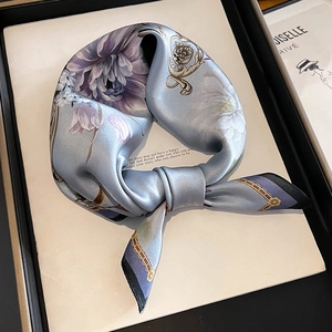 Elegant light blue silk square scarf featuring purple floral patterns and gold chain borders