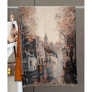 Détail d'une écharpe en tricot style peinture à l'huile avec pompons et motif urbain