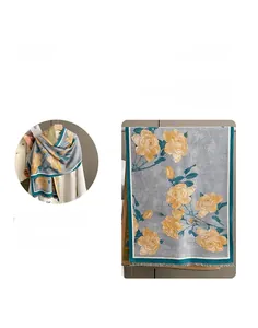 Detail of grey-green scarf with yellow rose patterns and fine tassel edges