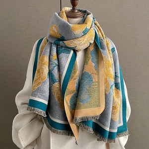 Thick warm winter scarf with floral print and fringe tassels in yellow blue grey colors