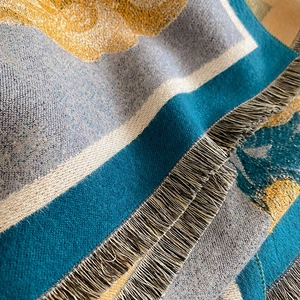 Close-up of thick winter scarf featuring colorful weave texture and long fringe details
