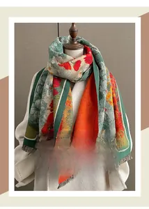 Detailed close-up of a thick autumn shawl with gingko leaf pattern and frayed tassels