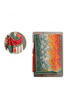 Detail of floral ginkgo leaf pattern on thick cashmere-feel scarf with fringe tassels