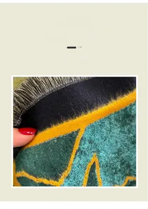 Detailed close-up of soft cashmere-like fabric texture with geometric pattern and fringes