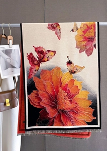 Detail of floral butterfly print on winter cashmere shawl with delicate fringe edges