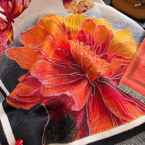 Detailed macro view of vibrant orange floral pattern and soft knit texture on shawl scarf