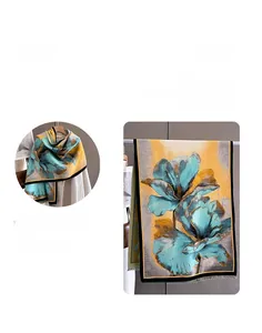 Close-up of floral cashmere feel shawl with tassels in blue, yellow and grey patterns