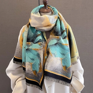 Floral cashmere-style scarf in mint green and yellow with fringes on a mannequin