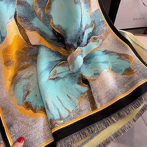 Detailed close-up of blue and yellow cashmere-feel scarf with fine fringe edges