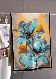 Detailed view of winter cashmere-like scarf with abstract floral print and fringe edges