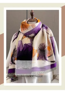 Detail of cashmere-like scarf with purple floral patterns and soft tassel edges