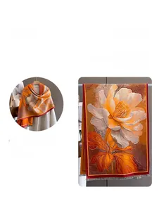 Detailed view of orange and yellow floral cashmere-feel scarf with soft fringe edges
