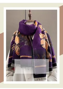 Detail of purple scarf with yellow ginkgo leaf pattern and fringe trim on a mannequin